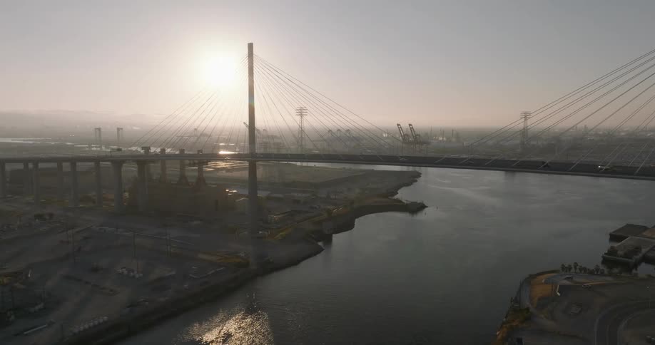 Aerial view of a suspension bridge near the docks at morning