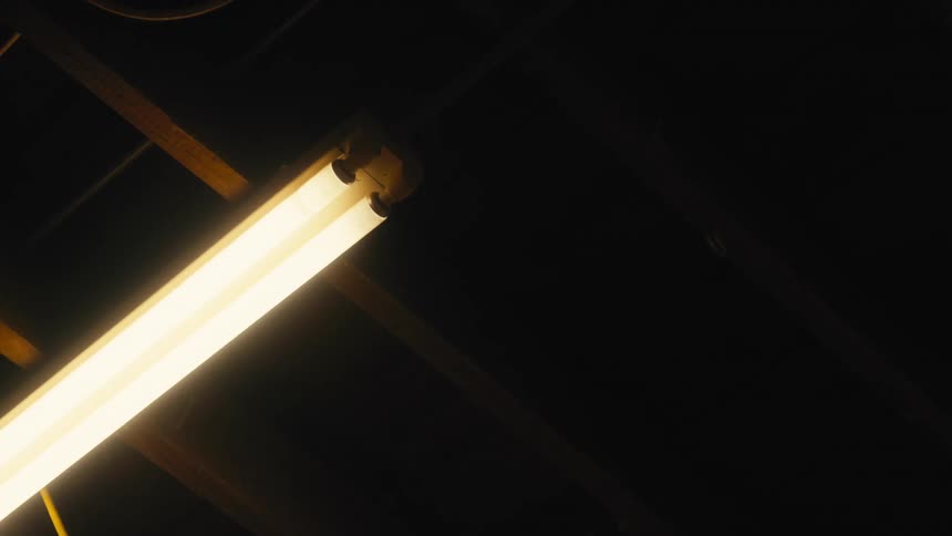 Light on a wooden floor turning on in a dark environment
