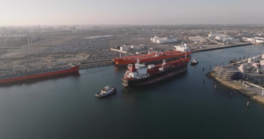 A harbor featuring sizable cargo vessels docked close to the shoreline
