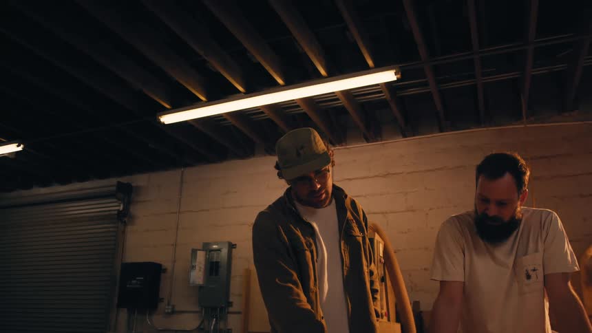 Two men in a garage talking