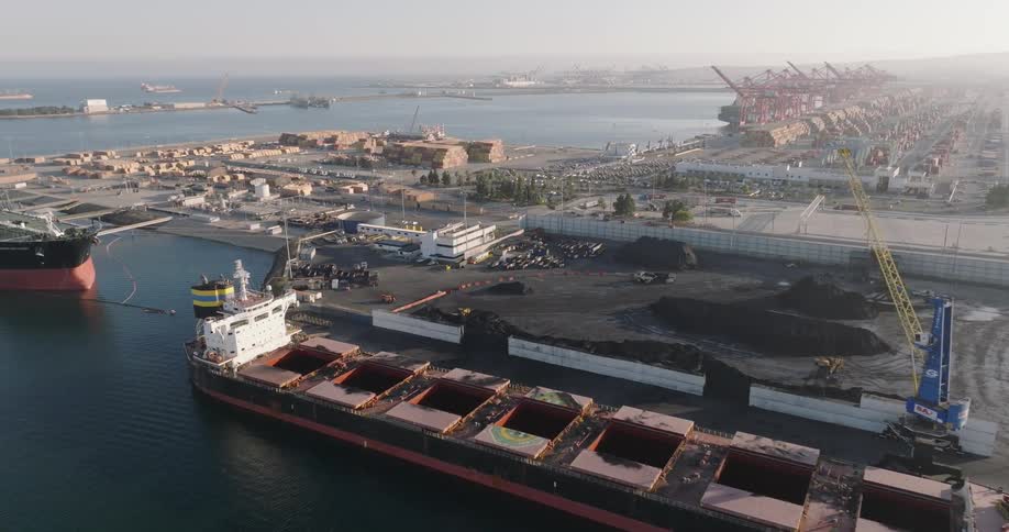 Aerial of the construction of a seaport with ships anchored off the coast