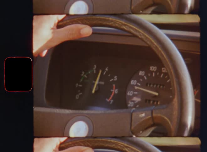 The hands of the driver hold onto the steering wheel of an old car as the speedometer and rpm counter go up due to the increasing speed tempo or velocity while driving fast or racing on a rural road or street on a sunny summer morning or day