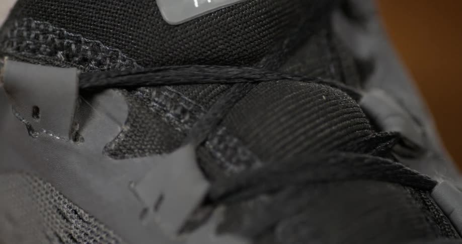 A person is tying their shoelaces