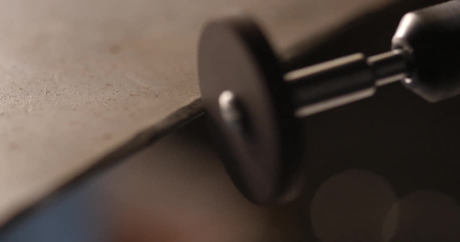 Smoothing an edge using a spinning wheel