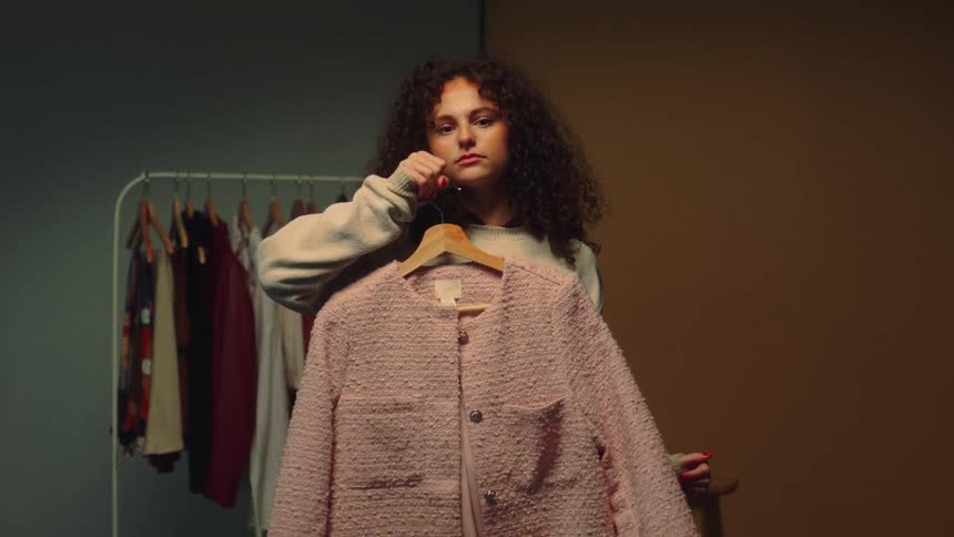 A girl choosing clothes to wear