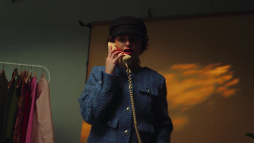 A woman in elegant clothes answering the phone