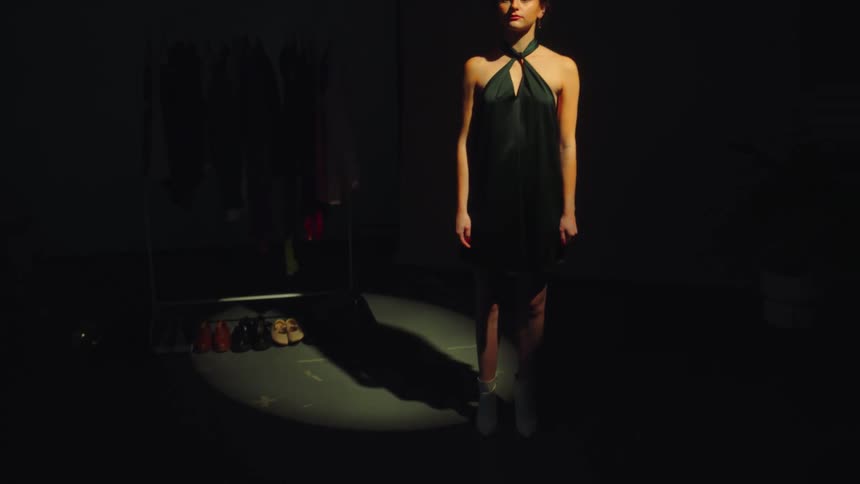 A woman at a photo shoot in an elegant dress