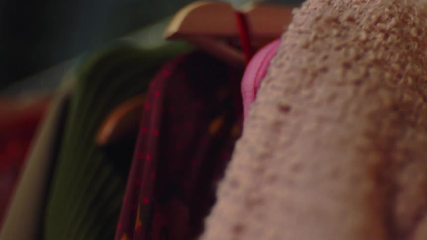 Close up of clothes hanging in the closet