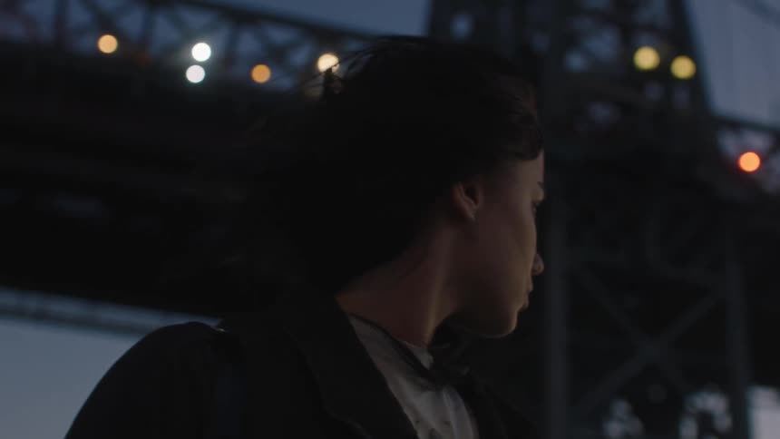 Closeup of a womans face in the city at dusk