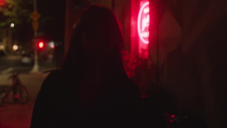 Young woman walking on the city streets at nighttion