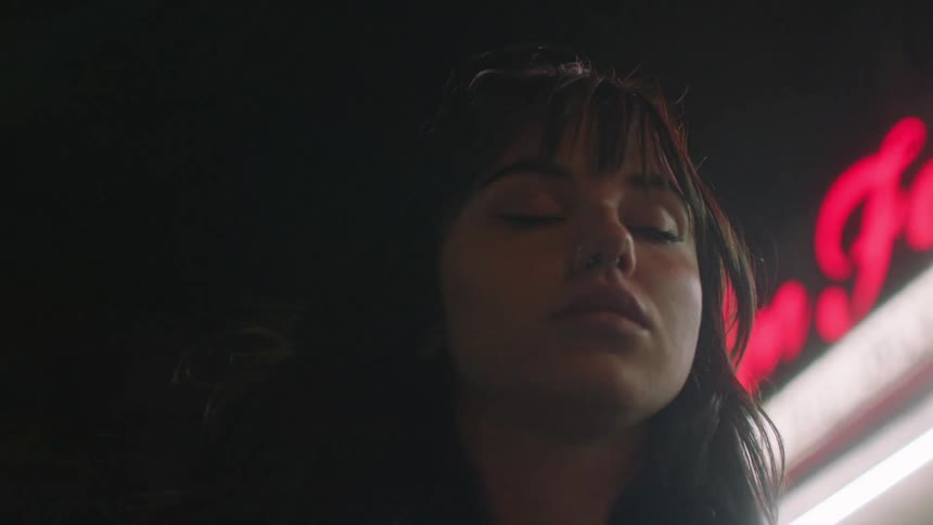 A clip of a lady looking drunk and walking by herself on the street