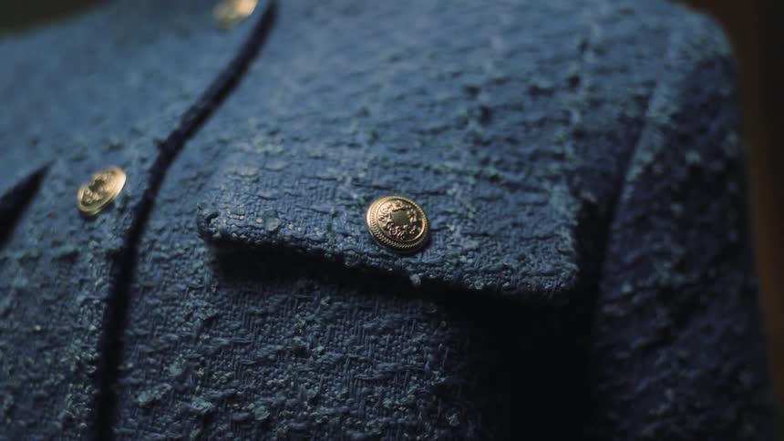 A blue coat with golden buttons