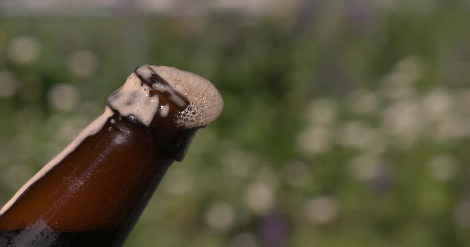 A person takes the cap off a bottle