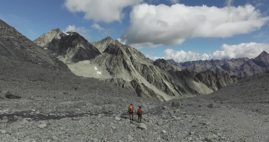 Skyline of people on top of a rocky mountain observing the landscape