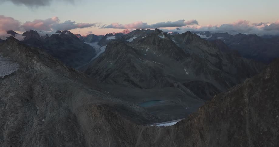 An aerial view captures the rugged beauty of a mountainous area where peaks and valleys form a breathtaking and untamed landscape