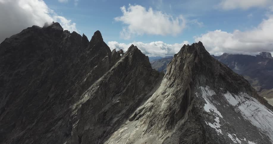 Panorama of peaks cliffs in mountains on a day with a cloudy sky
