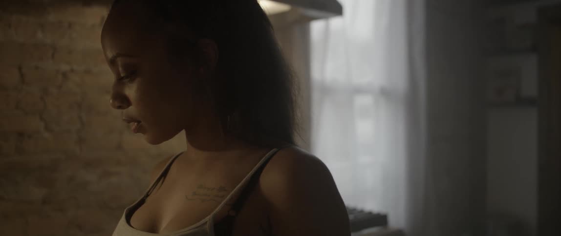 A woman eats some food in a kitchen