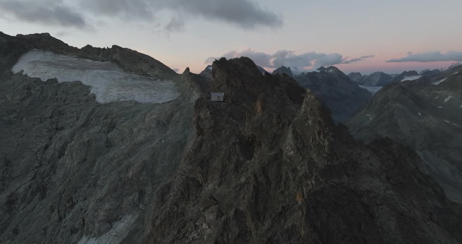 Panorama of geological peaks and mountains on a morning with a pink sky