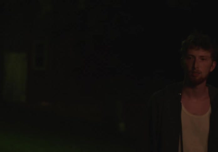 Man walking at night and joining a circle of friends