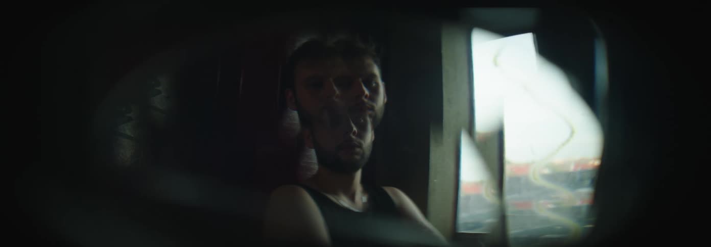 A man observing the landscape through the window