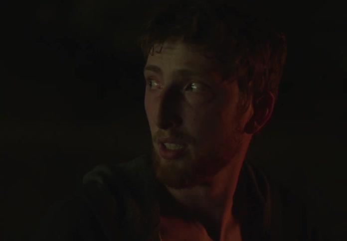 Portrait of a young man with a startled facial expression at night