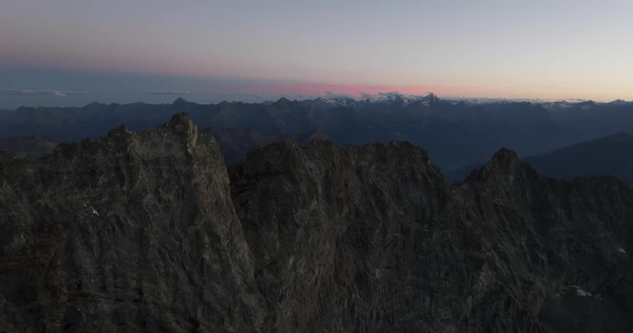 The sun is rising on the mountain range