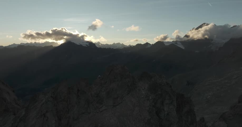 Aerial view of a snowy mountain range at sunrise