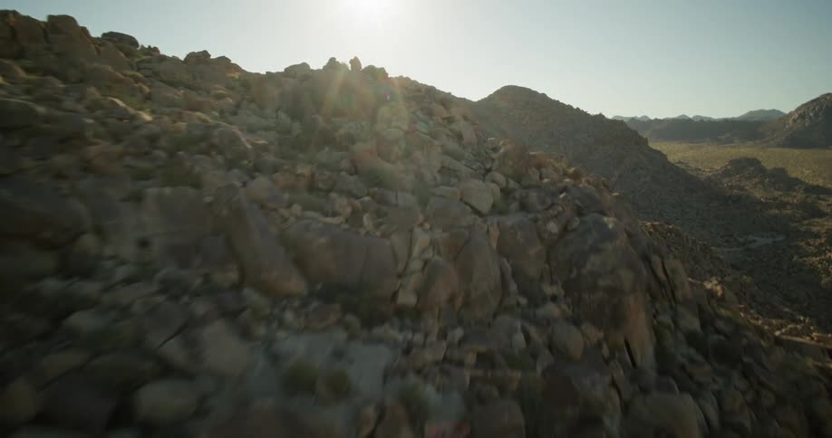 Rocky desert hills under a blue sky and midday sun