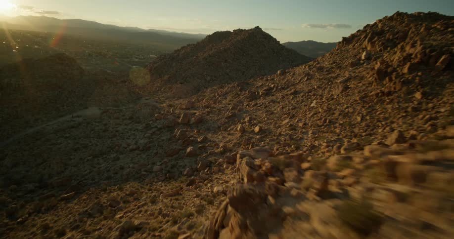 View of mountains formed by geological rocks with the morning sun on the horizon