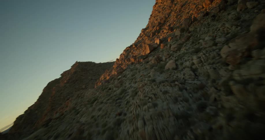 Rocks and stones forming peaks and mountains against a morning sky