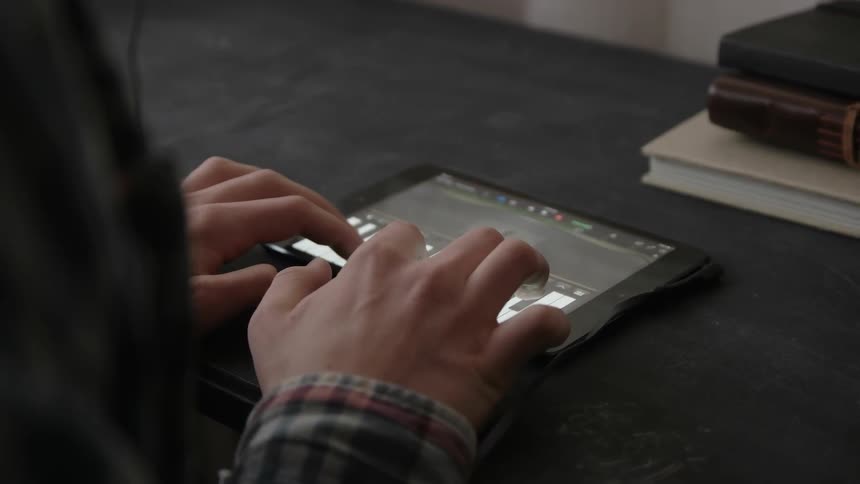 A person is playing piano on a tablet
