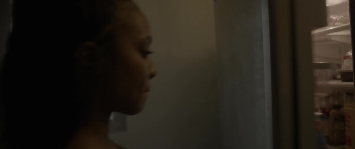A woman picks a jar from a shelf