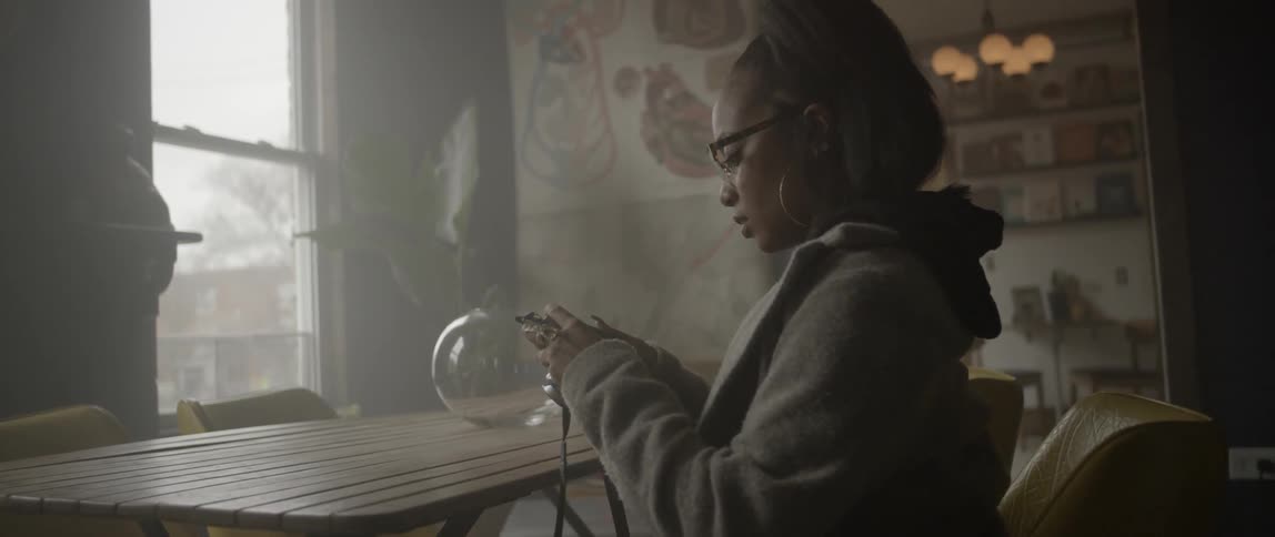 A woman pushes buttons on her camera