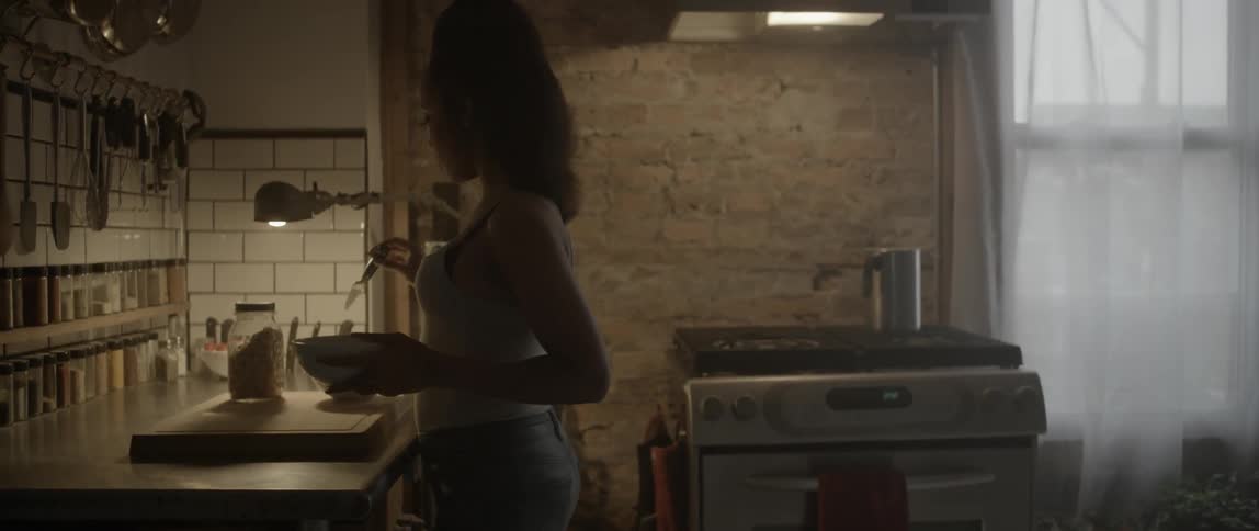 A woman mixes food in a bowl