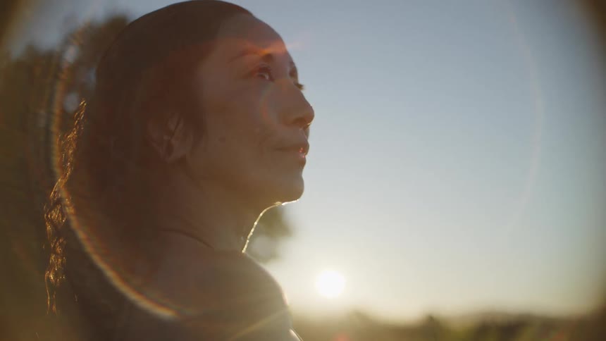 Portrait of a woman by a pool at sunset