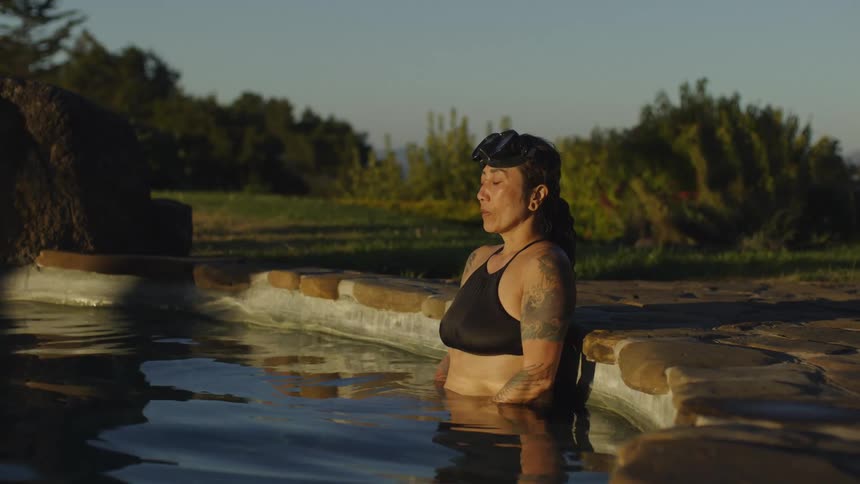 Woman performs breathing exercises in a pool
