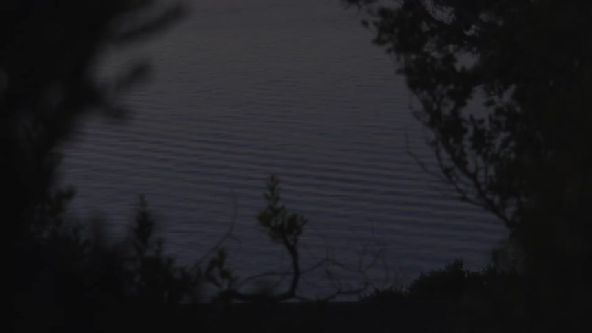 Seaside with gentle waves on the water during dusk