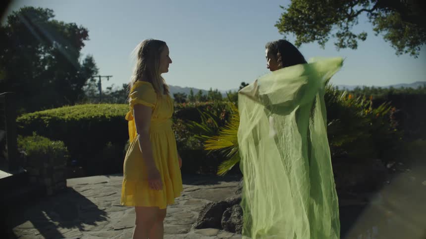A clip of two friends trying out a clothing material