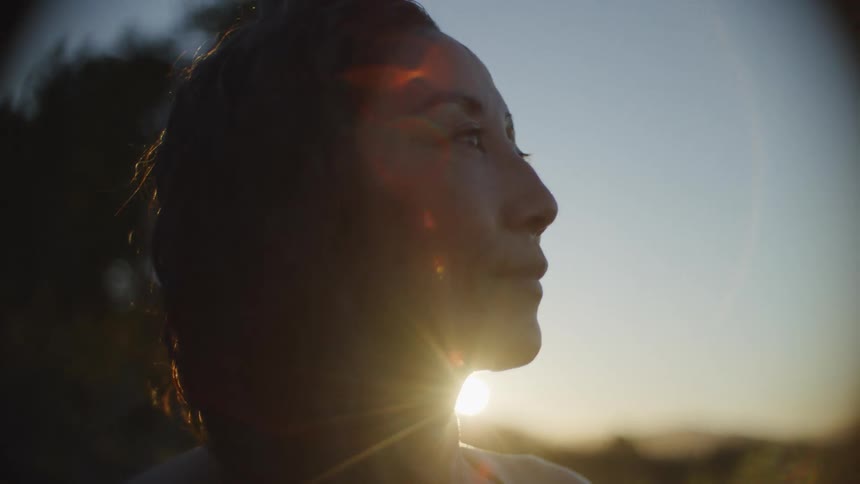 Woman lit by the warm glow of the setting sun