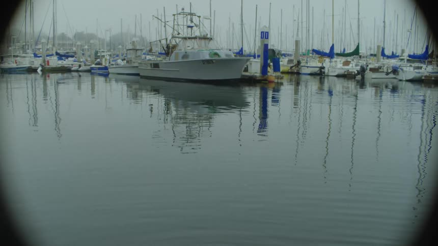 Boats in a harbor on a day with cloudy skies