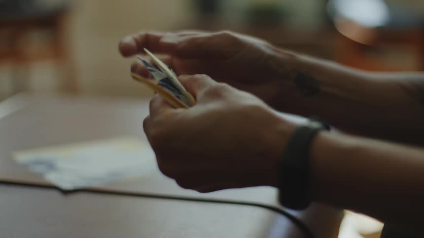 Closeup of a persons hands folding origami