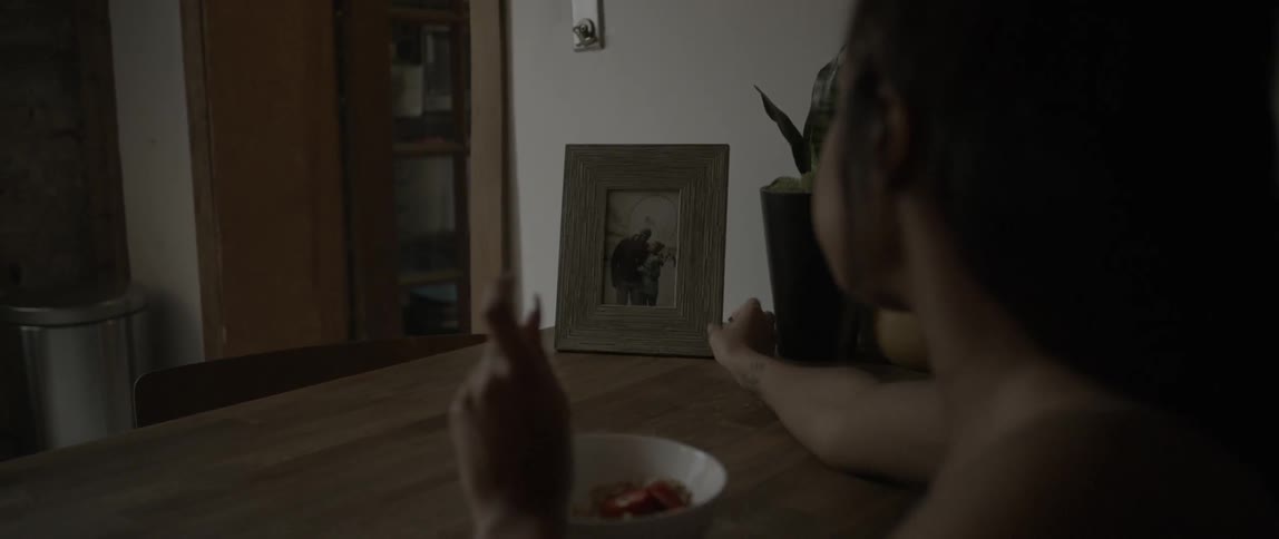 A woman is eating at the table