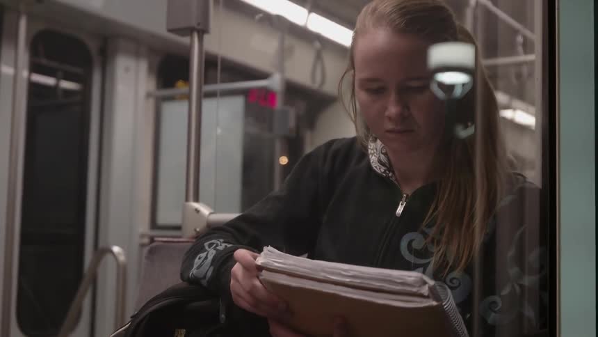 A woman opens her notebook