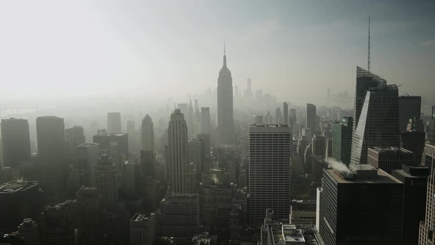 Panning shot of Empire State Building with fog