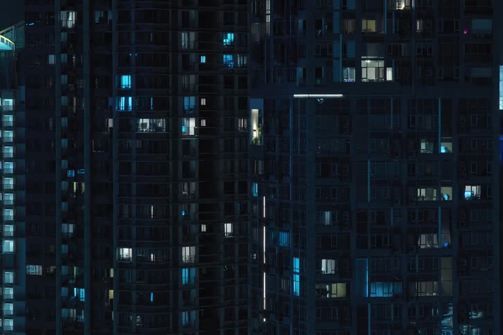 Time lapse of lights blinking and flashing on an apartment building at night