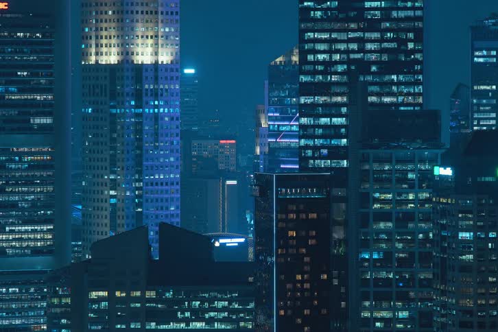 The lights in the city buildings flicker on and off
