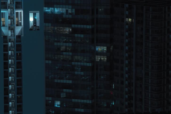 Time lapse of lights going off on an apartment building