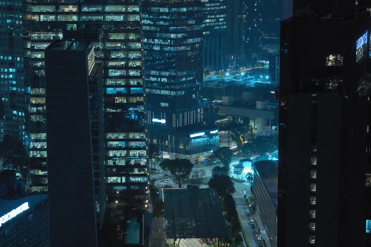 View of skyscrapers and traffic at night in time lapse