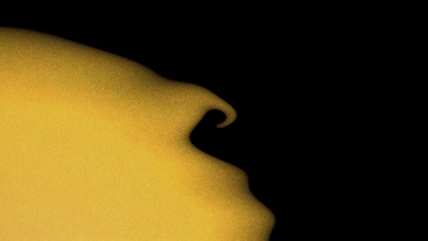 An orange and gold smoky element moving in a black background