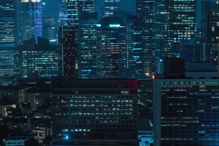 Skyline of a city with illuminated buildings at night